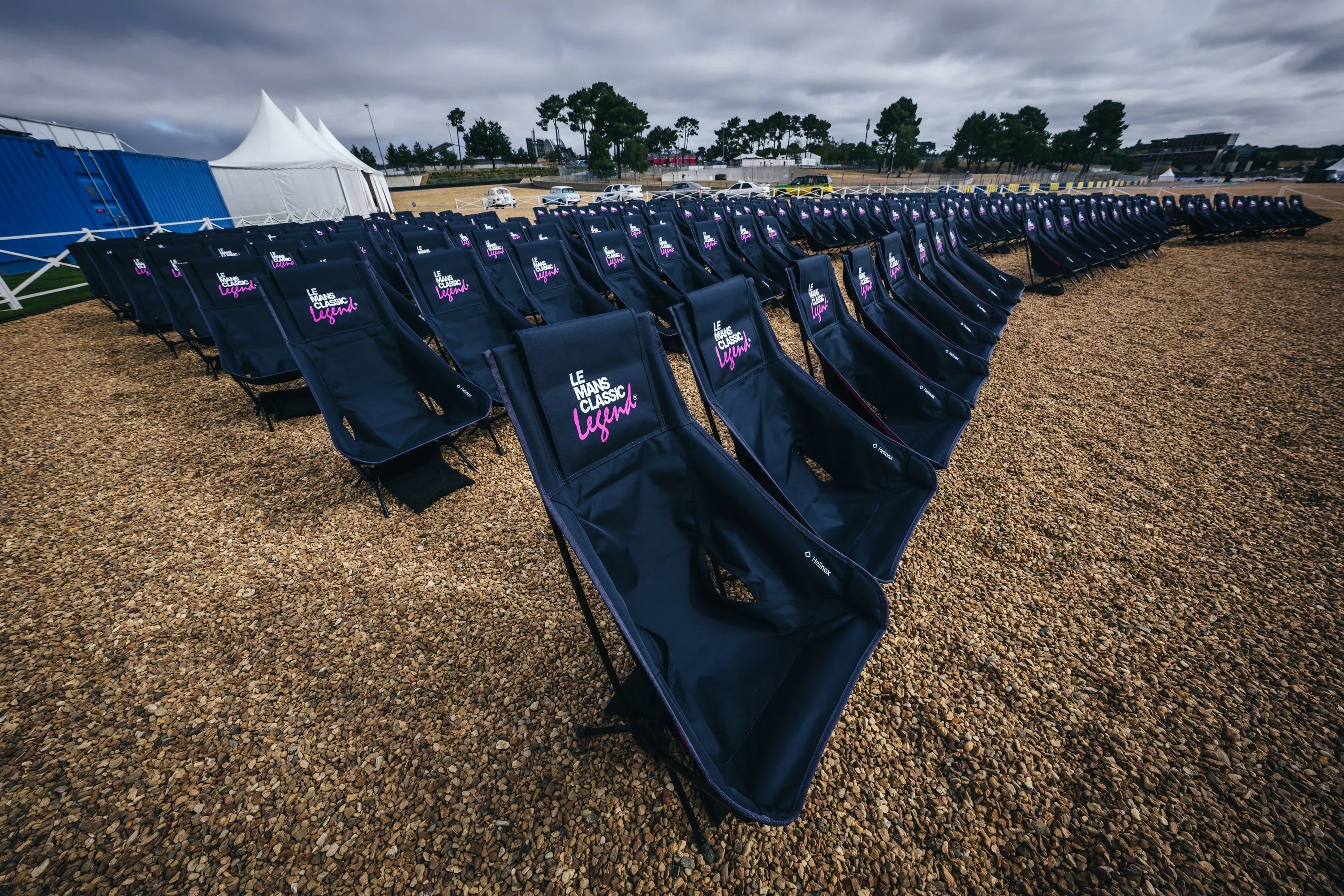 Rows of Helinox camping chairs arranged in an outdoor setting.