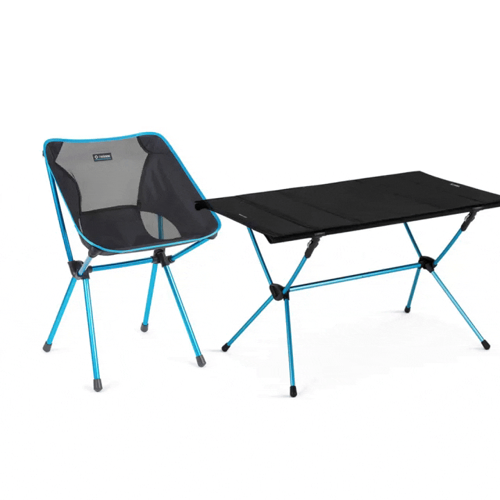 A single camping chair next to camping table.